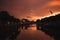 Dublin`s cityscape during a colorful sunset with clouds and seagulls over Liffey river