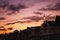 Dublin`s cityscape during a colorful sunset with clouds and seagulls over Liffey river