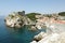 Dubrovnik city walls with a fortress overlooking s