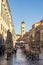 Dubrovnik, Croatia - Aug 22, 2020: Bell tower view from empty stradun street in old town morning sunrise