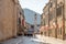 Dubrovnik, Croatia - Aug 22, 2020: Empty stradun street in old town with view of bell tower cupola in summer morning