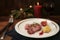 Duck breast with mashed parsnip, fig and red sauce, festive holiday dinner with candle and Christmas decoration against a rustic