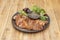 Duck dish cooked with cantonese duck recipe with sauce and assorted lettuce sprouts on wooden table