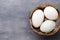 Duck eggs on a cage gray background