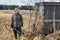 A duck hunter stands next to an old shelter