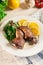 Duck legs confit with orange and salad