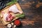 Duck legs on cutting board, Raw meat. Dark background. Top view. Copy space