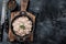 Duck pate Rillettes de Canard in a pan with greens. Black background. Top View. Copy space