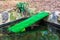 Duck ramp covered with synthetic green grass helps ducklings to climb in and out of the water
