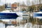 Duck swimming in front of colourful yachts docked at marina of Lecco town. Picturesque waterfront of Lecco located between famous