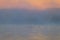 Ducks float along a calm lake as the morning fog lifts in early autumn at Silver Lake, Castile, NY