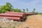 Ductile iron pipes stocked in open space of a rural village store yard.