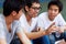 Dude, thats hilarious. A group of asian youths laughing together while sitting outdoors.