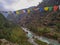 Dudh Koshi snow river in mountain valley and colorful prayer flags in Nepal