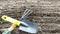 Dug up land in a greenhouse in a garden bed. Gardening tools on the surface of the earth. Top view, movement to the right