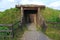 Dugout or dug-out, pit-house, earth lodge, cellar dug from logs in autumn fores