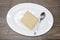 Dukan Diet. Fresh delicious diet cake at Dukan Diet on a porcelain plate with a spoon on a wooden background.