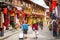 Dukezong old town scenic view with old wooden houses shops and tourists in Shangri-La Yunnan China