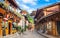 Dukezong Tibetan old town scenic street view with shops and Dafo temple in background in Shangri-La Yunnan China