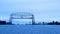 Duluth Minnesota aerial lift bridge raises as iron oar ship approaches from Lake Superior.