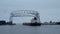 DULUTH, MN - 27 OCT 2019: Ore Ship goes under aerial lift bridge toward Lake Superior.