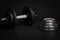 Dumbbell and barbell discs for workout on black background