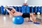 Dumbbell bench press on fit ball man gym workout