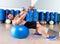 Dumbbell bench press on fit ball man workout at gym