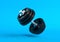 Dumbbell with black plates levitating in air on bright blue background