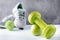 Dumbbell, green Apple, ball, grey sneakers, on white and grey background