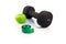 Dumbbell, green apple and measuring tape on a white background.