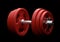 Dumbbell with red plates isolated on black background