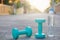 Dumbbell weights and bottle on street blurred background.Metaphor Fitness and workout concept exercise Health lifestyle muscle