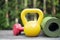 Dumbbell and yoga mat on table, fitness healthy and sport concept