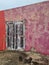 Dumbbells against a pink weathered wall in the Caribbean sun