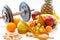 Dumbbells and assorted fruits and meter healthy lifestyle weight loss concept