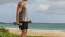 Dumbbells Biceps Curls exercise - fitness man exercising arms on beach