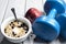 Dumbbells and bowl with yogurt