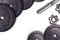 Dumbbells on carbon background. Dumbbells and weights are lying on the floor in the gym. Barbell set and gym equipment. Metal
