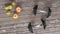 Dumbbells and fruits on a worn wooden plank table