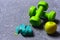 Dumbbells in green color, apple and cyan measuring tape