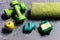 Dumbbells in green color, apple, towel, hand band and tape