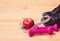 Dumbbells, measuring tape, apple and sneakers. Selective focus. Fitness, healthy and active lifestyles concept