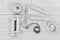 Dumbbells, measuring tape, jump rope and apple, top view. Barbells and centimeter near tools for weight loss. Workout