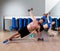 Dumbbells push-ups couple at fitness gym