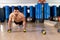 Dumbbells push-ups man at fitness gym