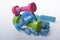 Dumbbells and skipping rope in cyan, pink and green color