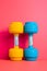 Dumbbells on vibrant, colorful background. Gym, fitness club concept. Close-up view. Be active, sporty. Healthy