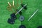 Dumbbells, weight discs, gloves and accessories for sport, on the grass, Fitness