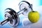 Dumbells and green apple